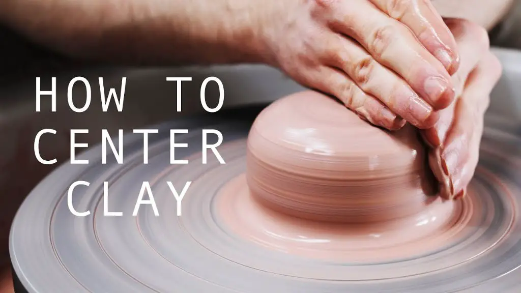 potter opening up centered clay on a pottery wheel 