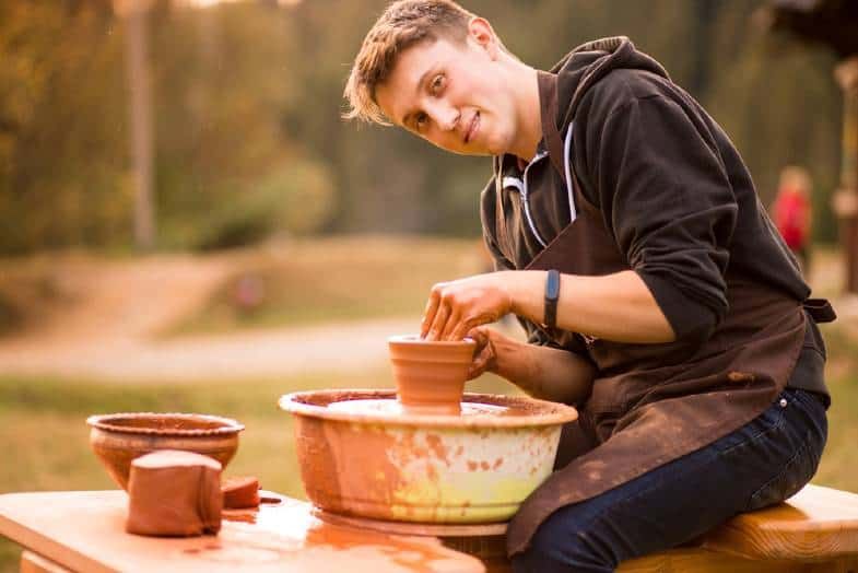 potter working on a plaster surface molding a clay pottery piece