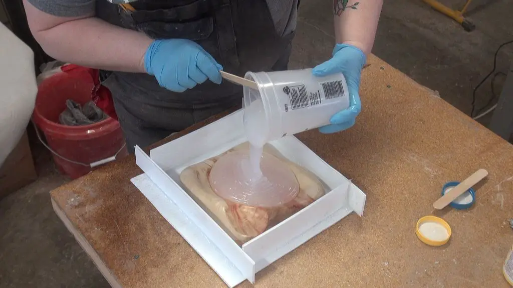 pouring silicone into a mold frame