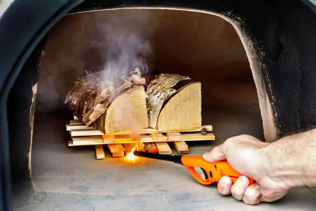 properly lighting the fire is key to heating up a clay oven