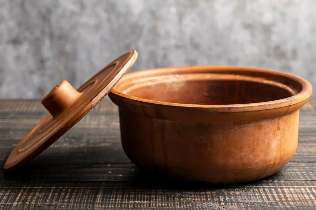 properly season and soak clay pots before cooking to prevent cracking and food sticking