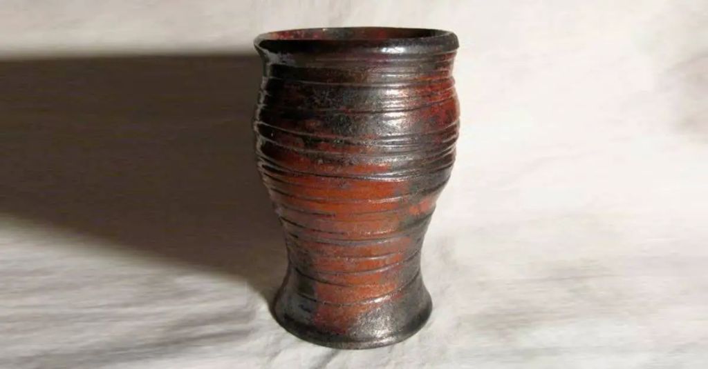 raku pottery pieces with cracked glazes resulting from the rapid cooling raku firing process.