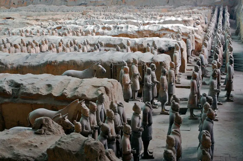 rows of terracotta warrior figures stand buried in pits