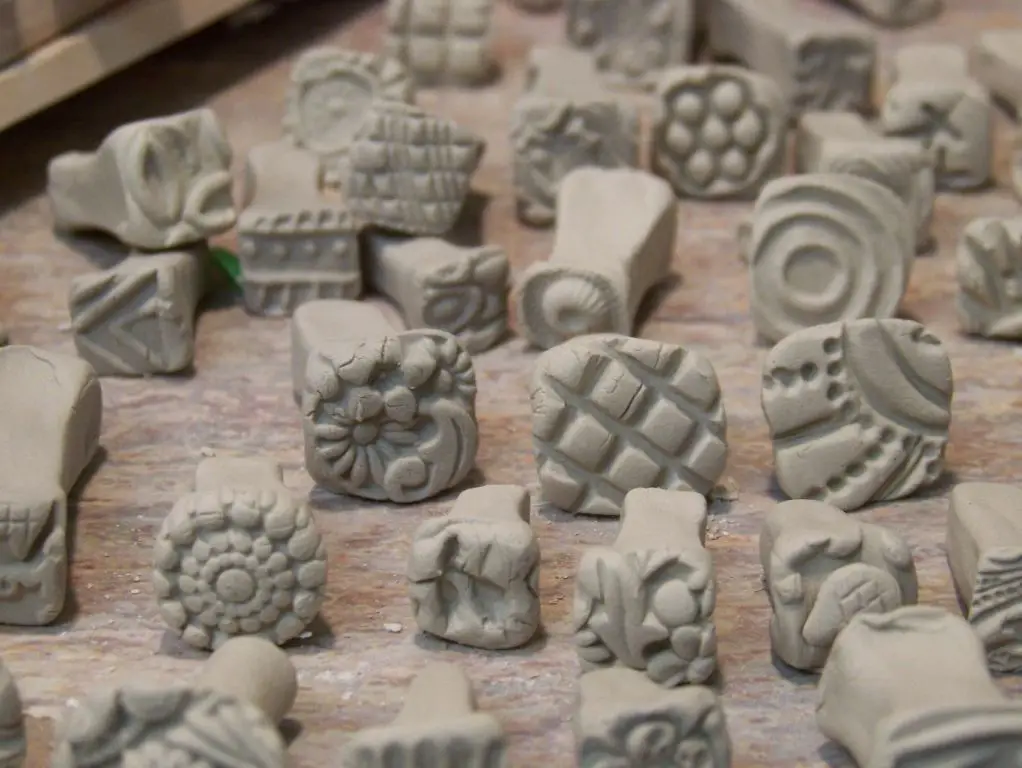 small stamps allow precision and intricacy for pottery decoration