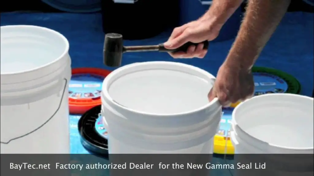 someone installing a gamma lid on a bucket