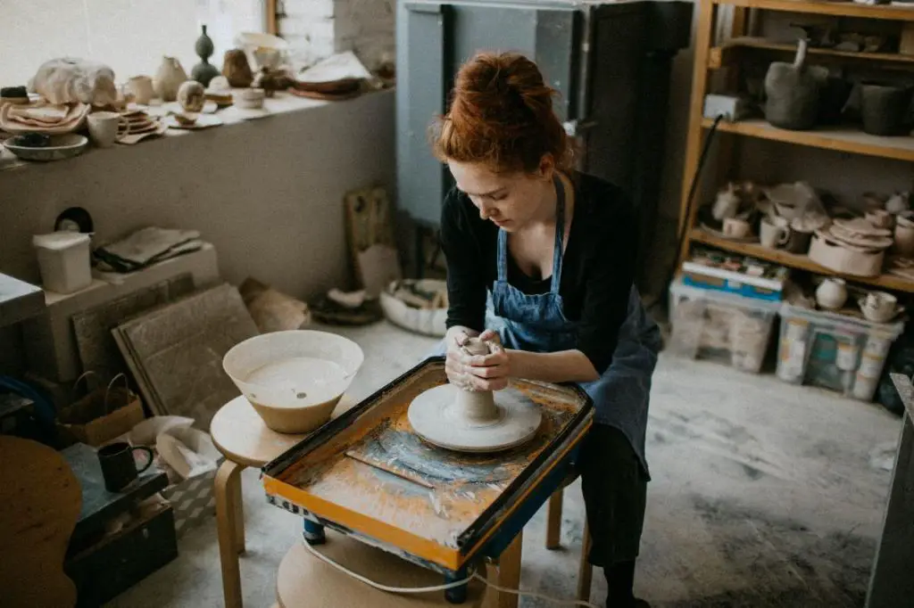 someone working on pottery at home in their own studio space