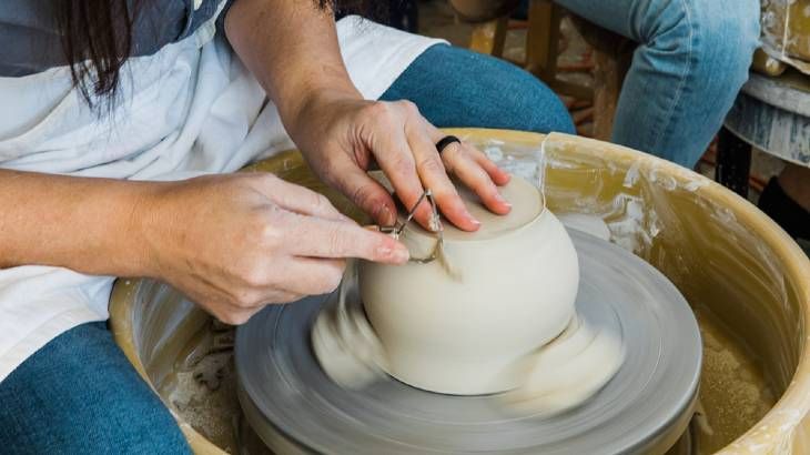 someone working with earthenware clay