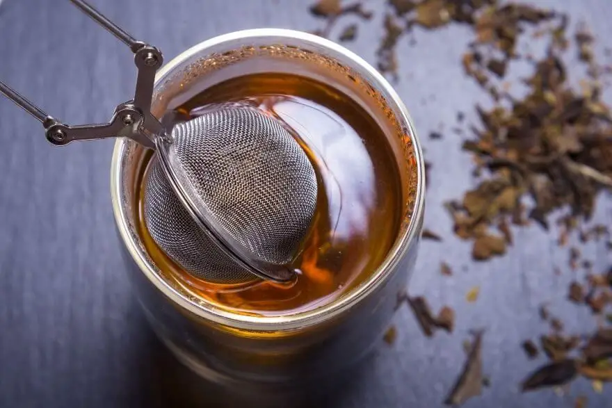 tea infuser being used to brew loose leaf tea