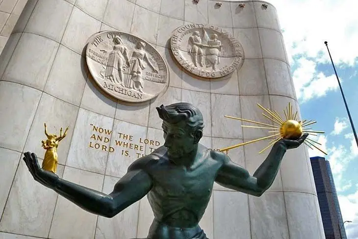 the spirit of detroit statue stands 26 feet tall and weighs over 16,000 pounds.