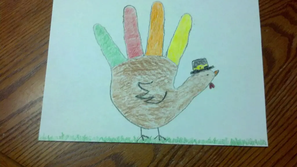 tracing your hand is the first step to creating a hand turkey art craft