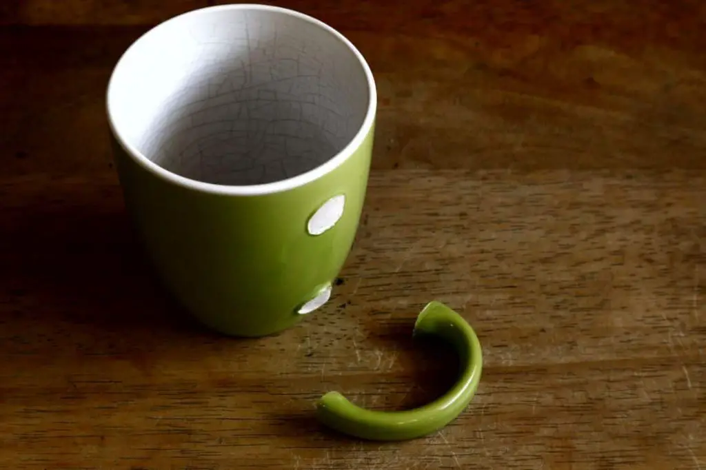 two ceramic mugs bonded together with epoxy glue.