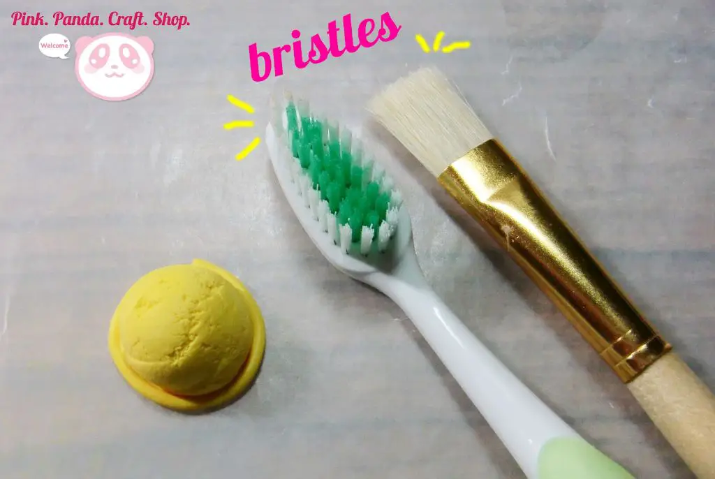 using a stiff bristle toothbrush to create interesting textures in polymer clay