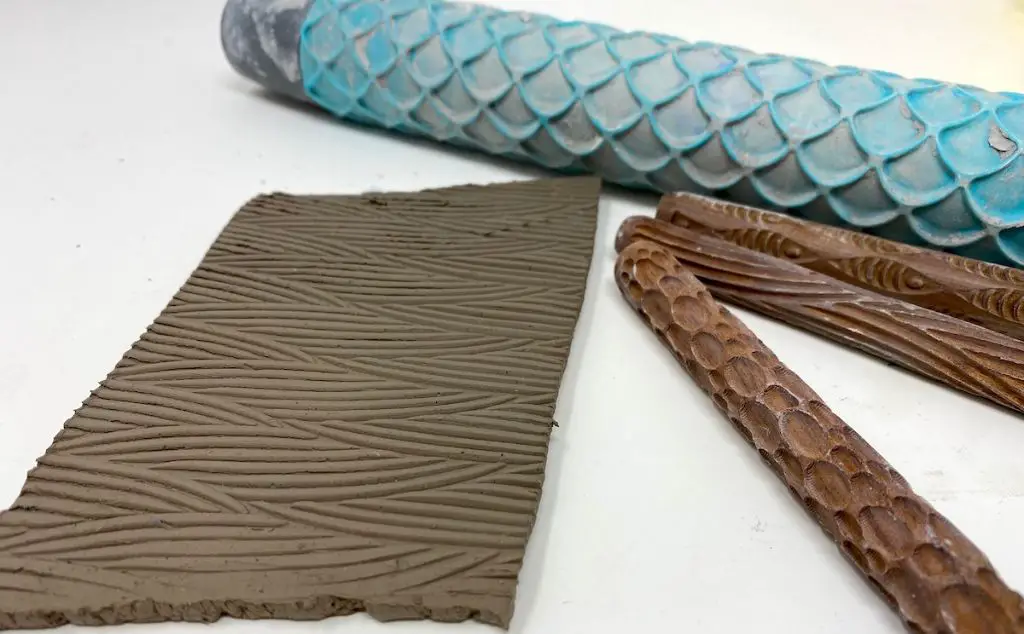 using various tools to create textures in clay sculptures