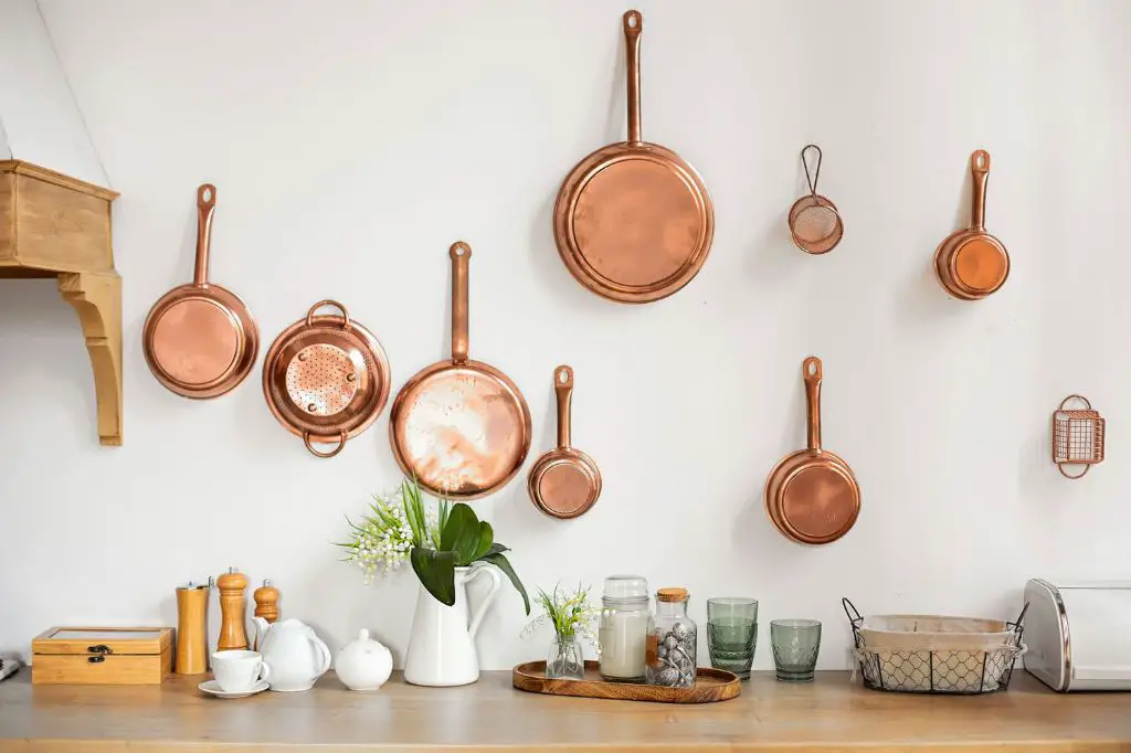 wall-mounted pot racks free up cabinet space by storing cookware vertically