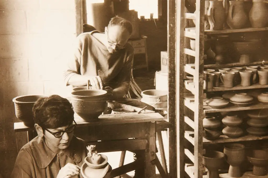 warren mackenzie working on pottery wheel next to his wife alix