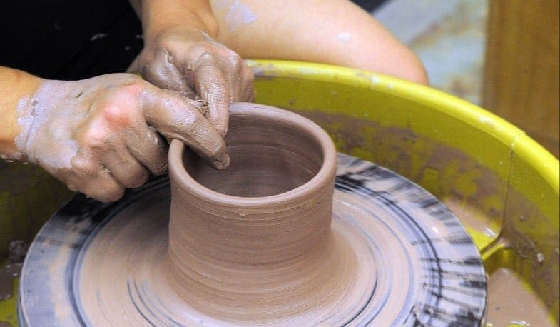 wheel throwing involves shaping clay on a potter's wheel