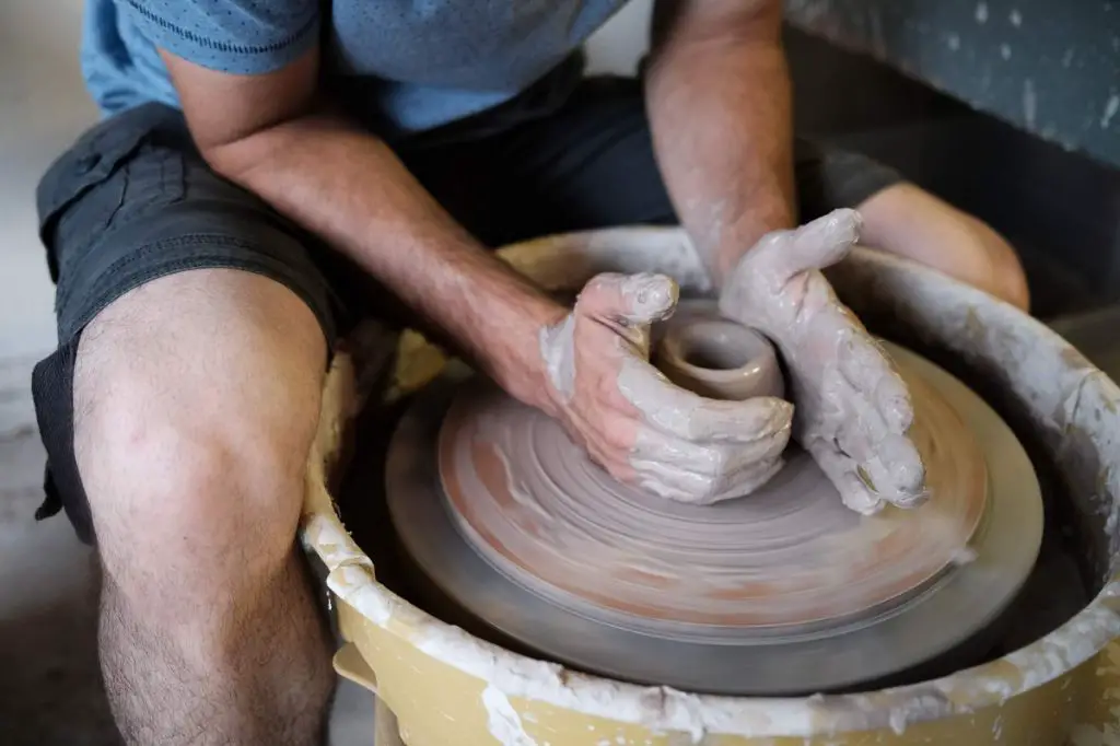 wheel throwing involves using your hands to shape spinning clay, which requires developing muscle memory through extensive practice.