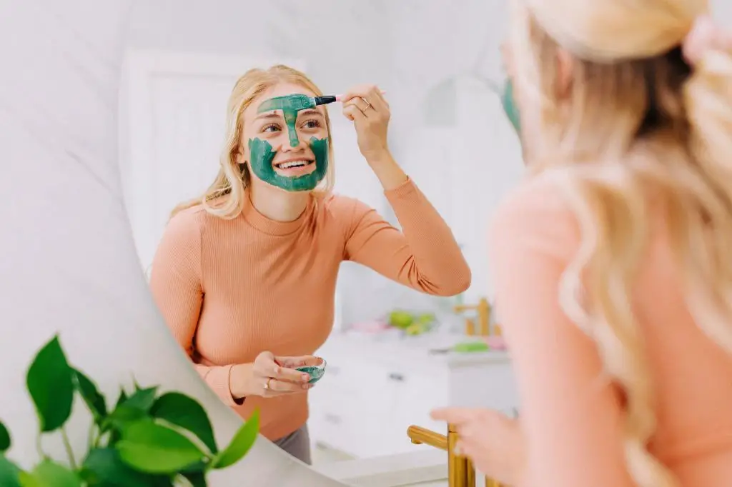 woman applying kaolin clay face mask