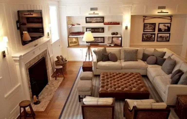 With a sectional couch configuration, there is a TV over the fireplace.