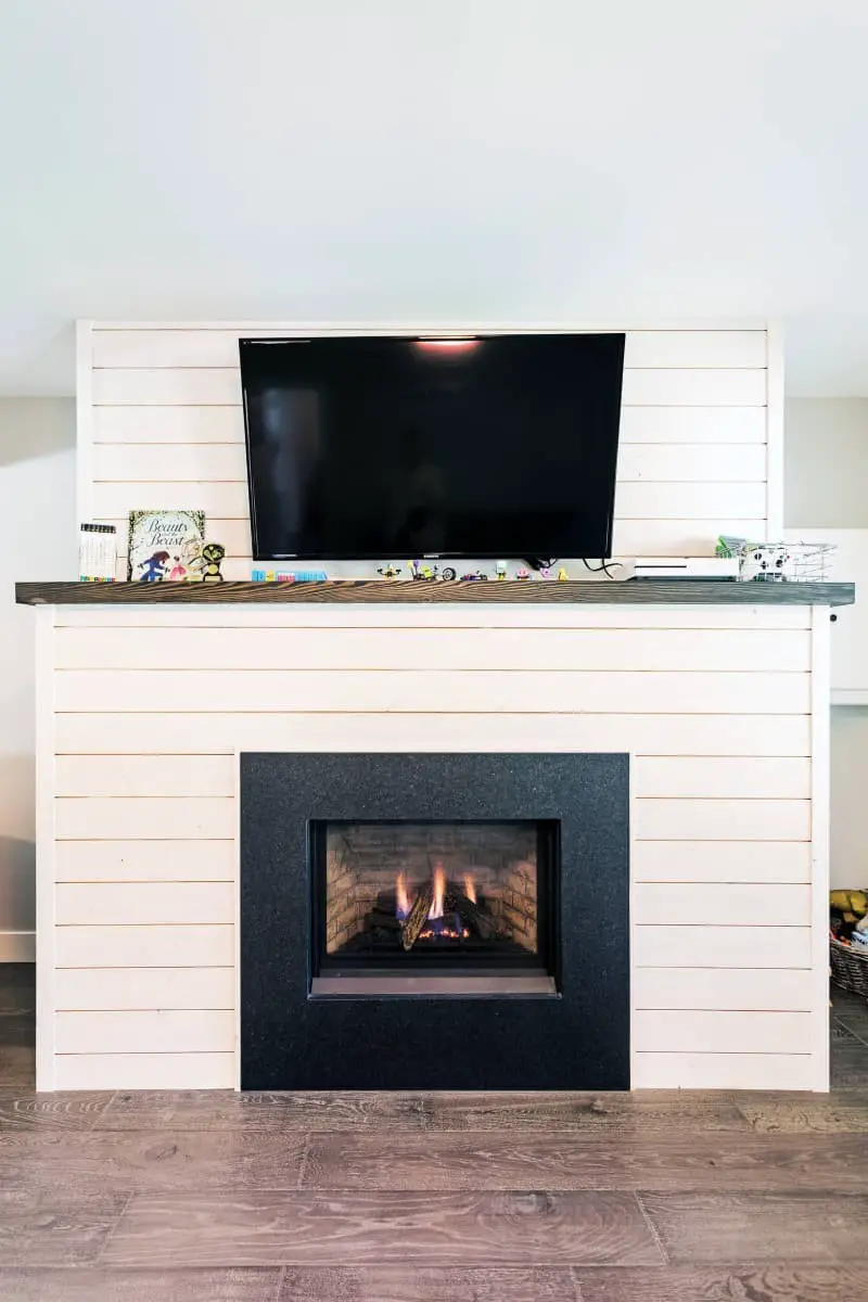 Shiplap accent wall ideas with TV and fireplace.