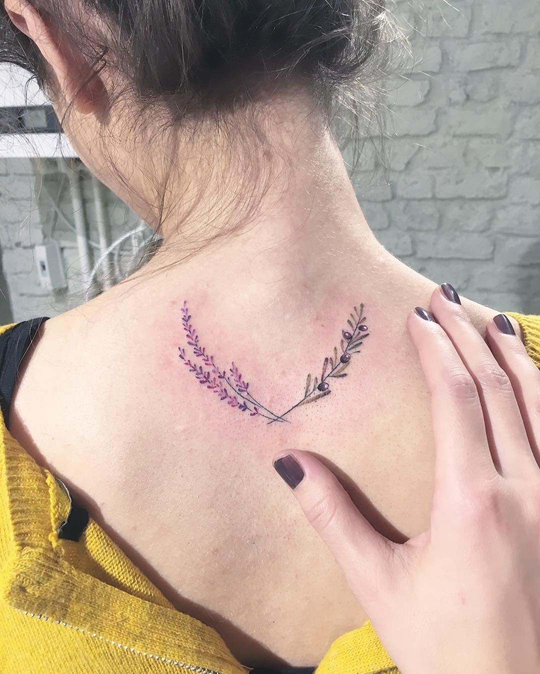 #10. The nape olive branch tattoo.