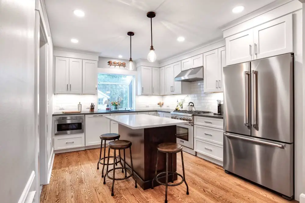 Stainless steel appliances + White cabinets.