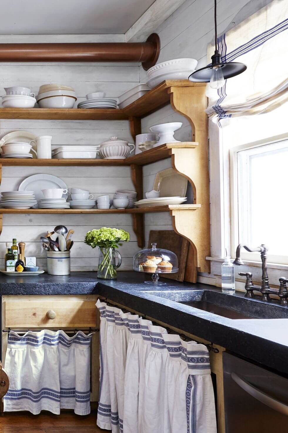 Pine shelves with blue countertops, and skirted storage from old linen tablecloth