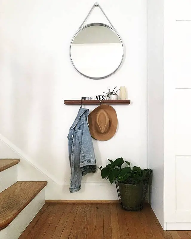 Wooden shelf with coat hooks and a mirror