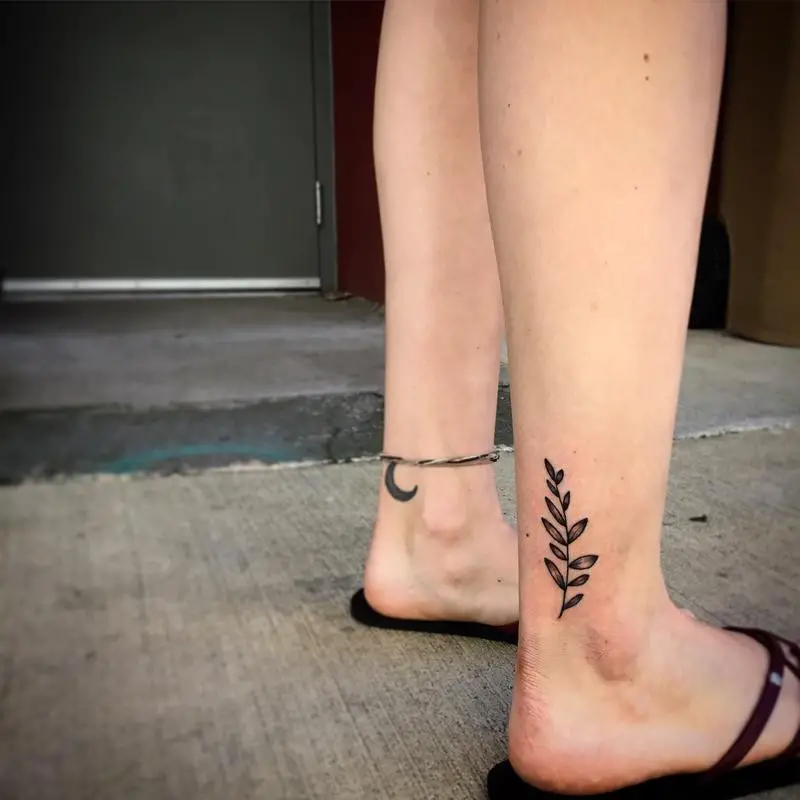 #6. The ankle olive branch tattoo.