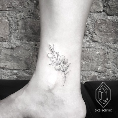 #6. The ankle olive branch tattoo.