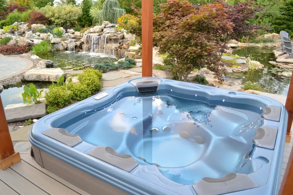 A hot tub with a pond across