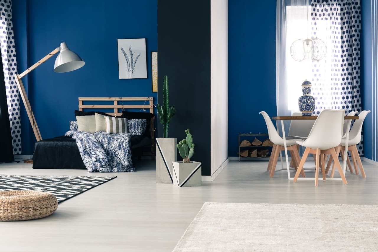 Electric blue walls and white and blue polka dotted curtains