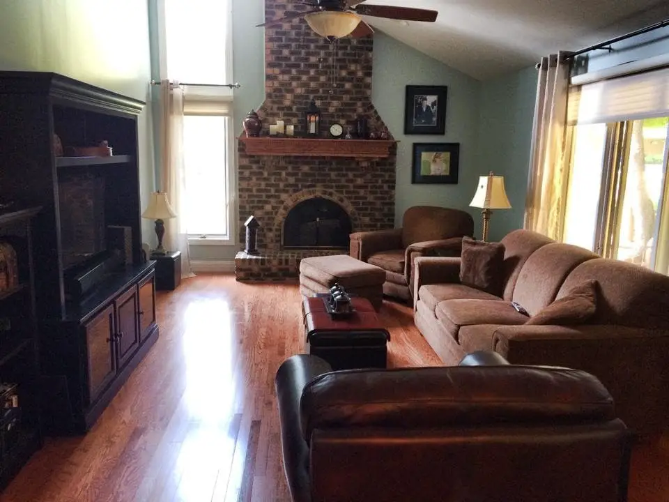 A narrow living area with a fireplace and a television.