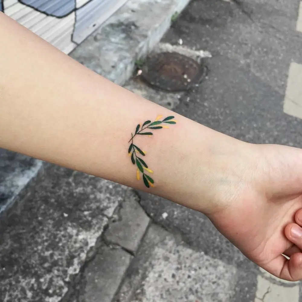 #4. The wrist olive branch tattoo.