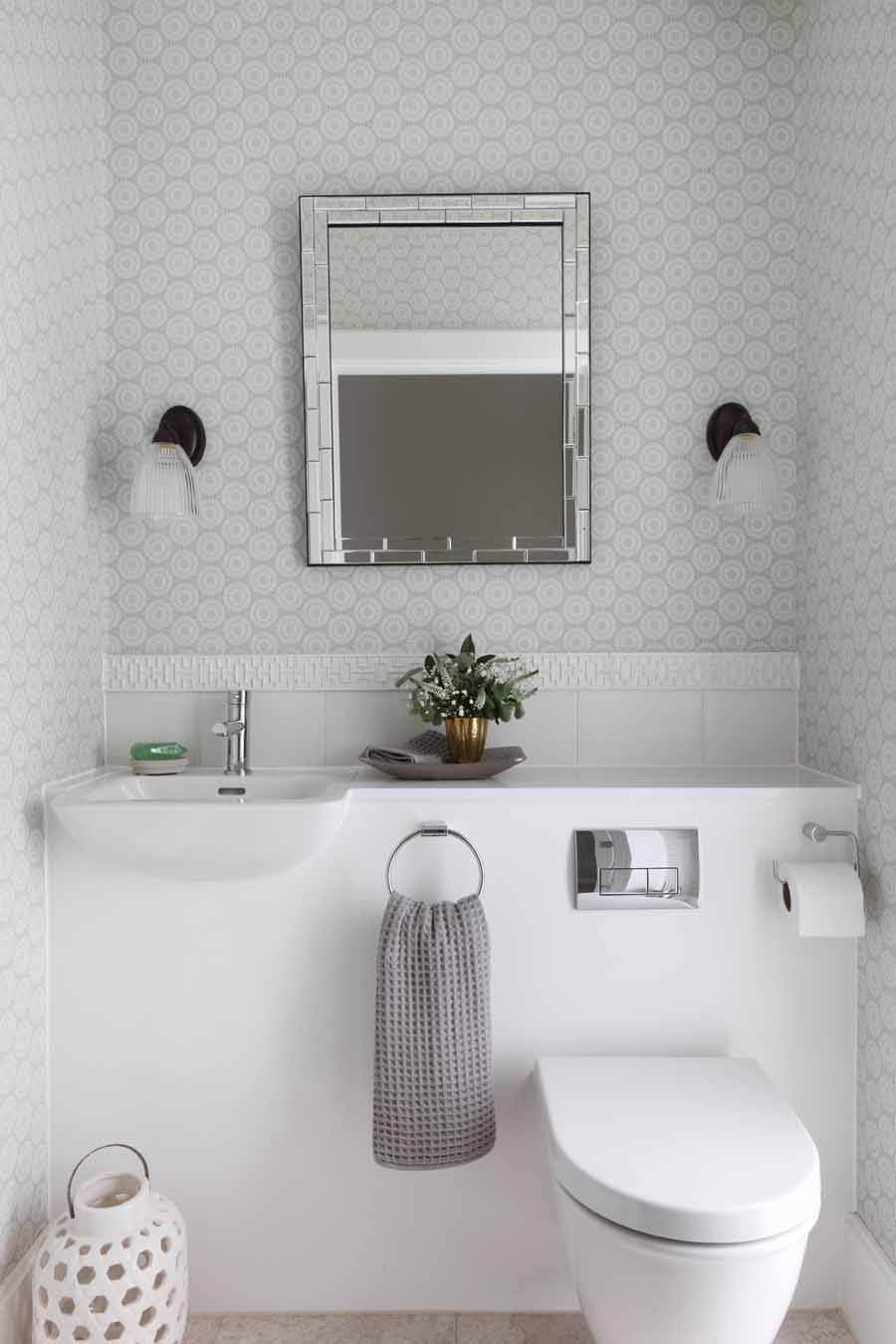 #13. Trendy powder room with an integrated sink, a wall-mount toilet, gray walls and white countertops