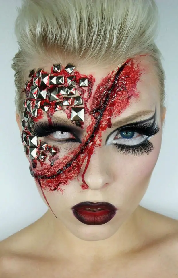 Girl with makeup for halloween with a wound in the middle of the face and estoperoles