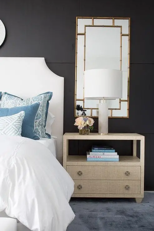 Prints and mirrors in a white and gold bedroom