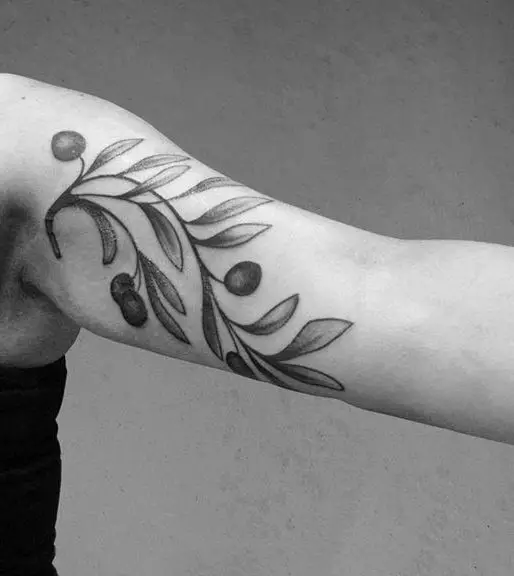 #3. The arm olive branch tattoo symbolizing victory.