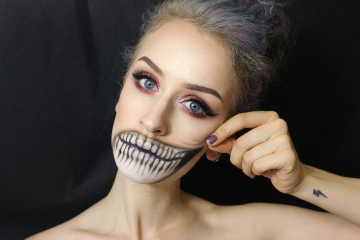 Girl with makeup for halloween With the mouth in the shape of a skull