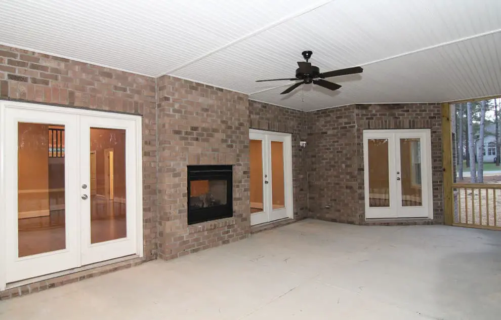 Screened in porch with electric fireplace.