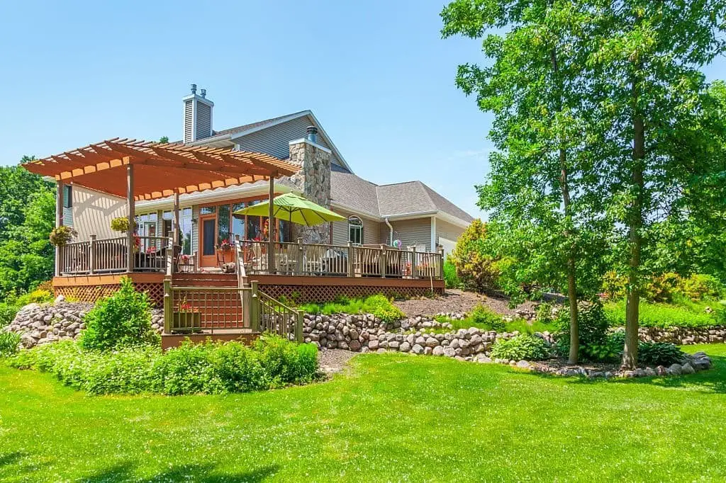 Backyard Oasis With Covered Porch and Waterfall