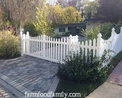 Bi-folding picket fence driveway gate