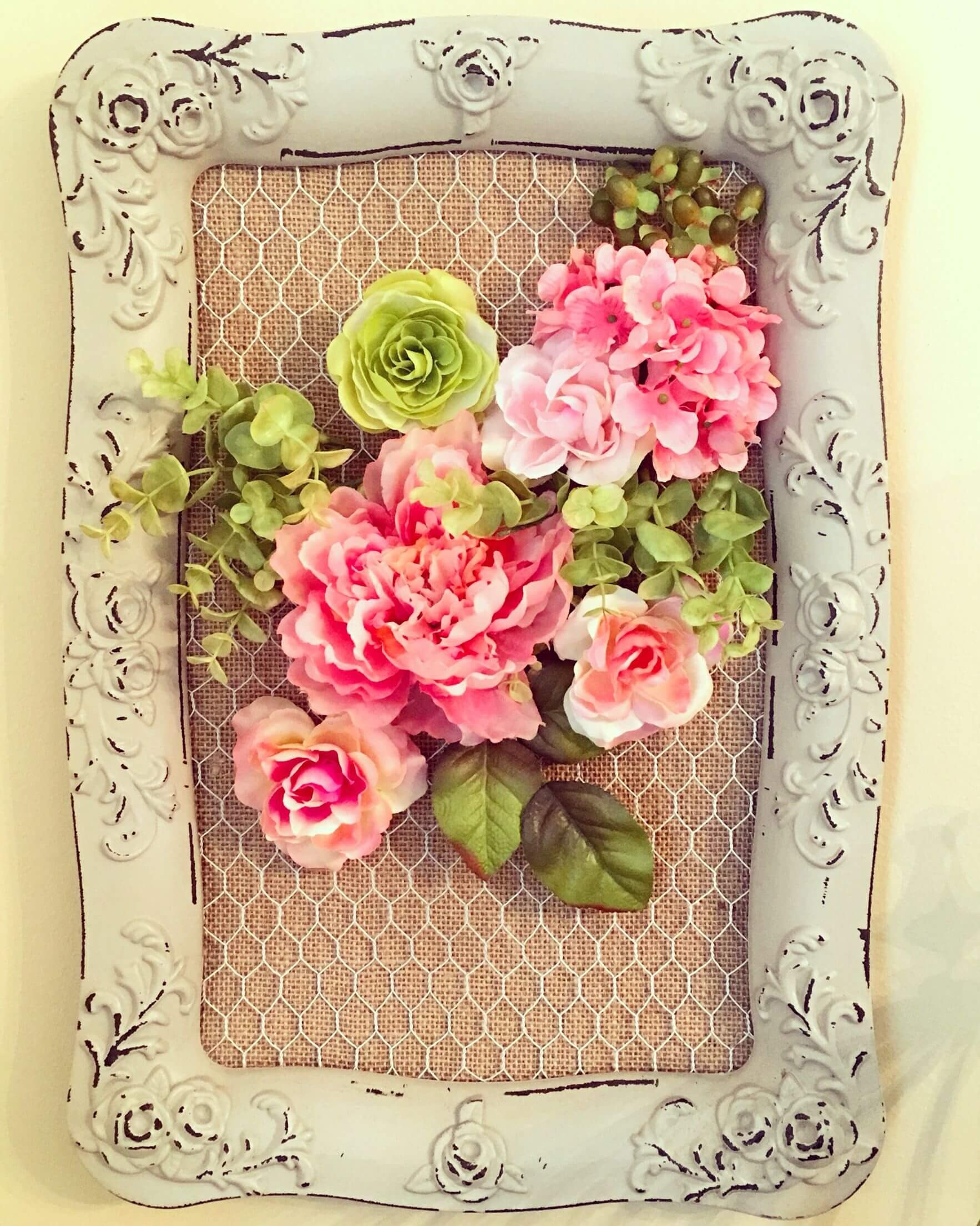 The upcycled mirror frame holding flowers