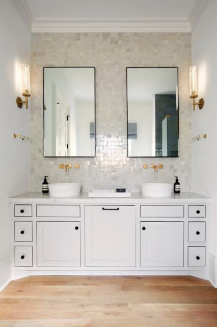 Use wall sconces on either side of the mirror.