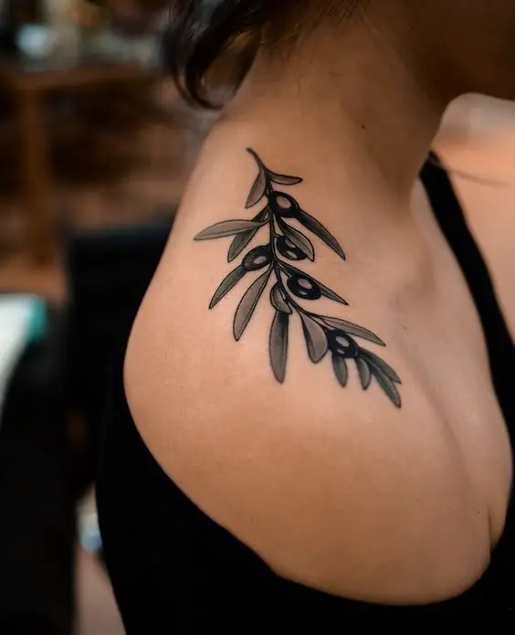 #2. The shoulder olive branch tattoo symbolizing peace and dignity.