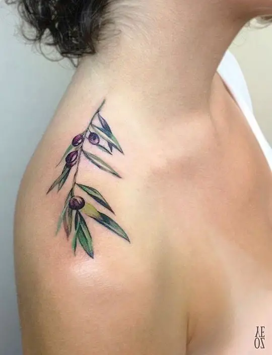 #2. The shoulder olive branch tattoo symbolizing peace and dignity.