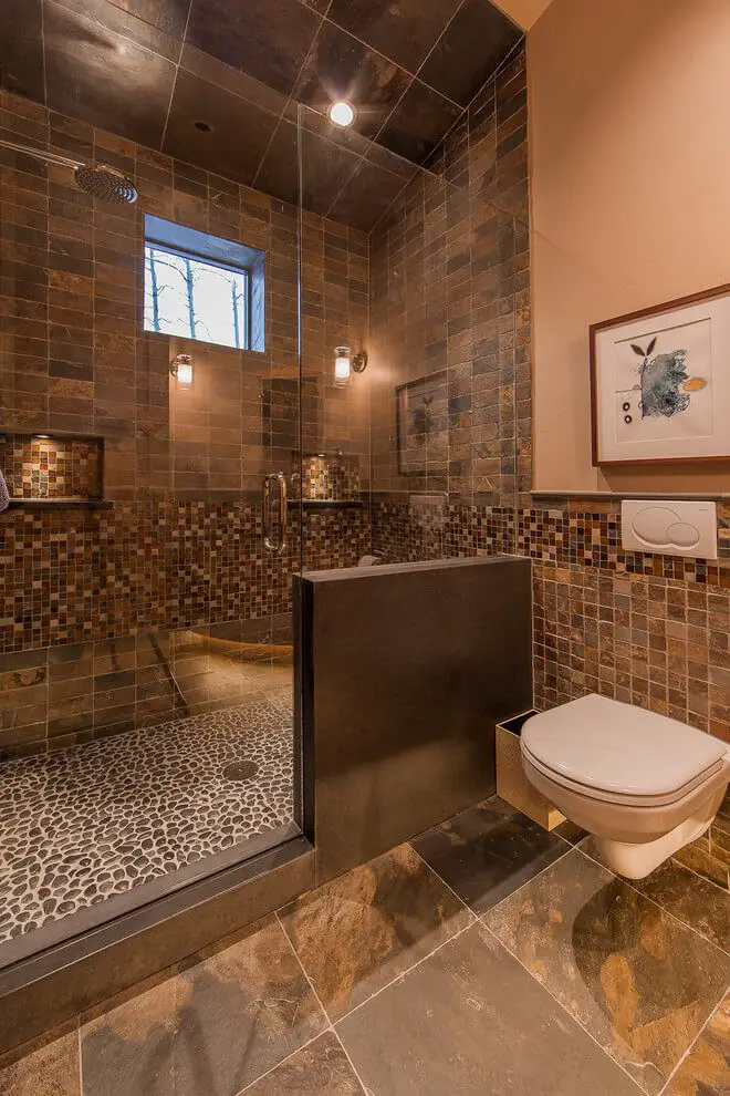 #9. Mountain style brown tile brown floor alcove shower with a wall-mount toilet