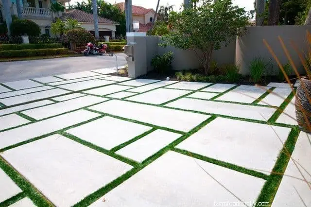 Block concrete driveway with grass