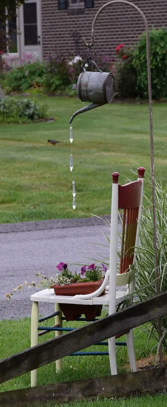 Old tin watering can with cane chair