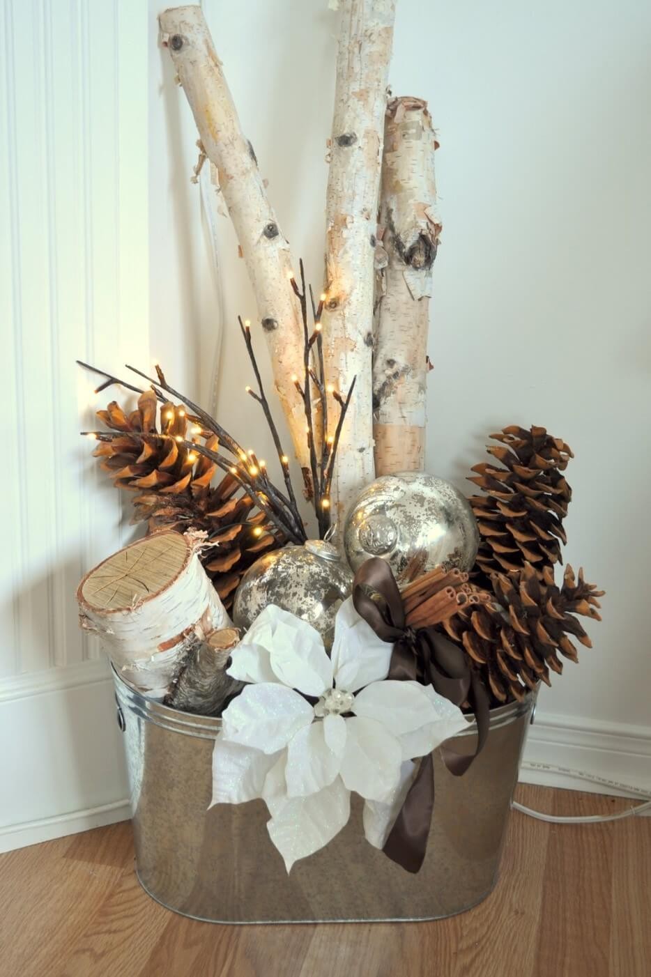 Metal basket with pinecones, ornaments, and branches